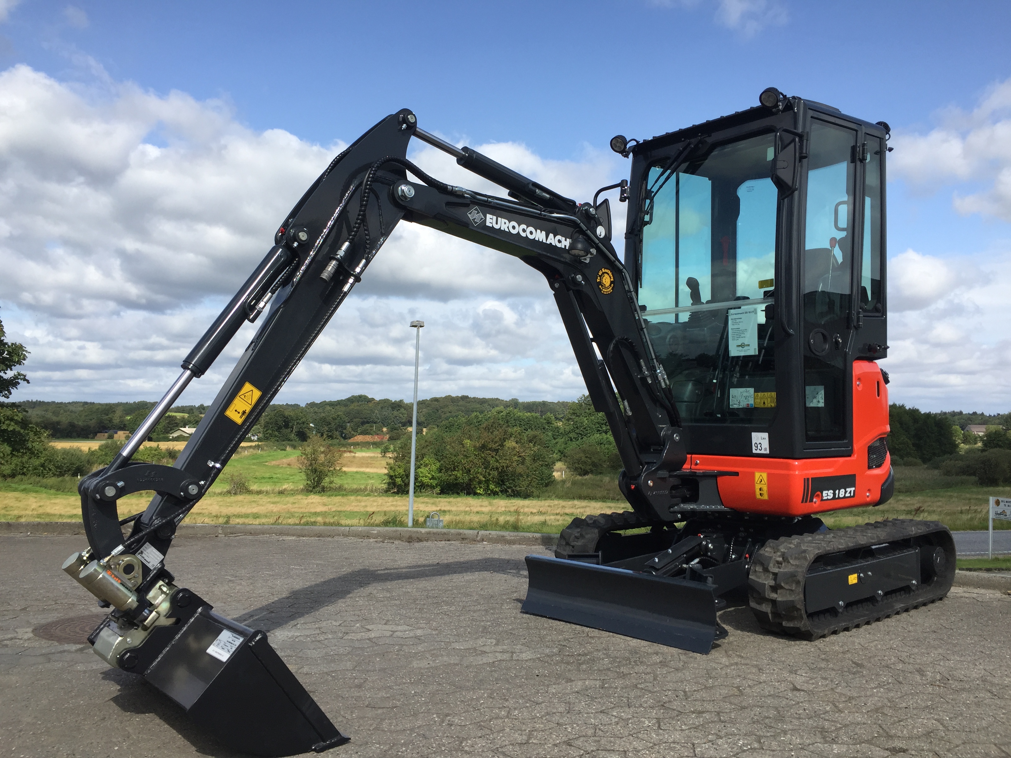 Eight shirts arranged on table in black, olive, grey, blue, white, red, mustard, and green.