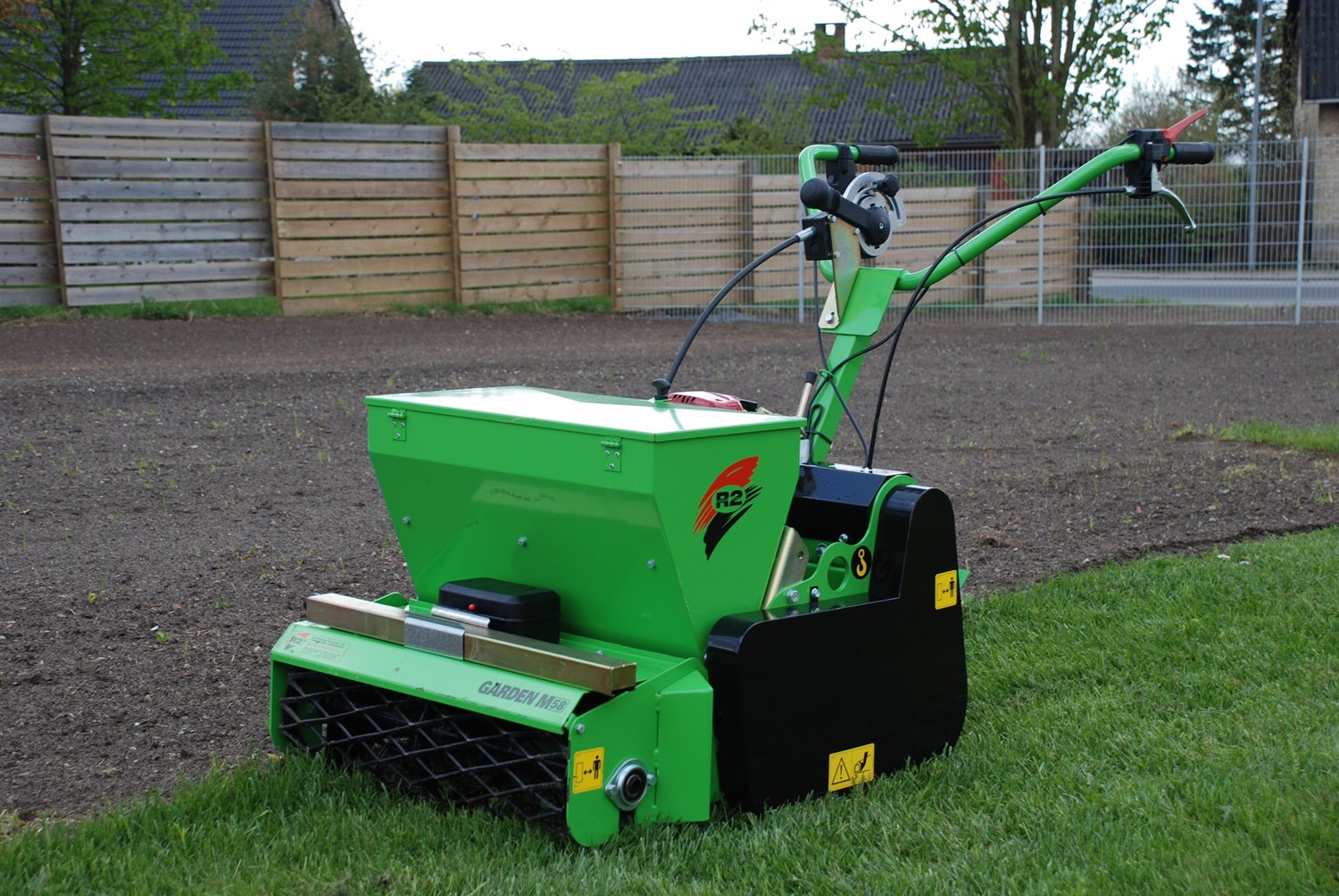 Eight shirts arranged on table in black, olive, grey, blue, white, red, mustard, and green.