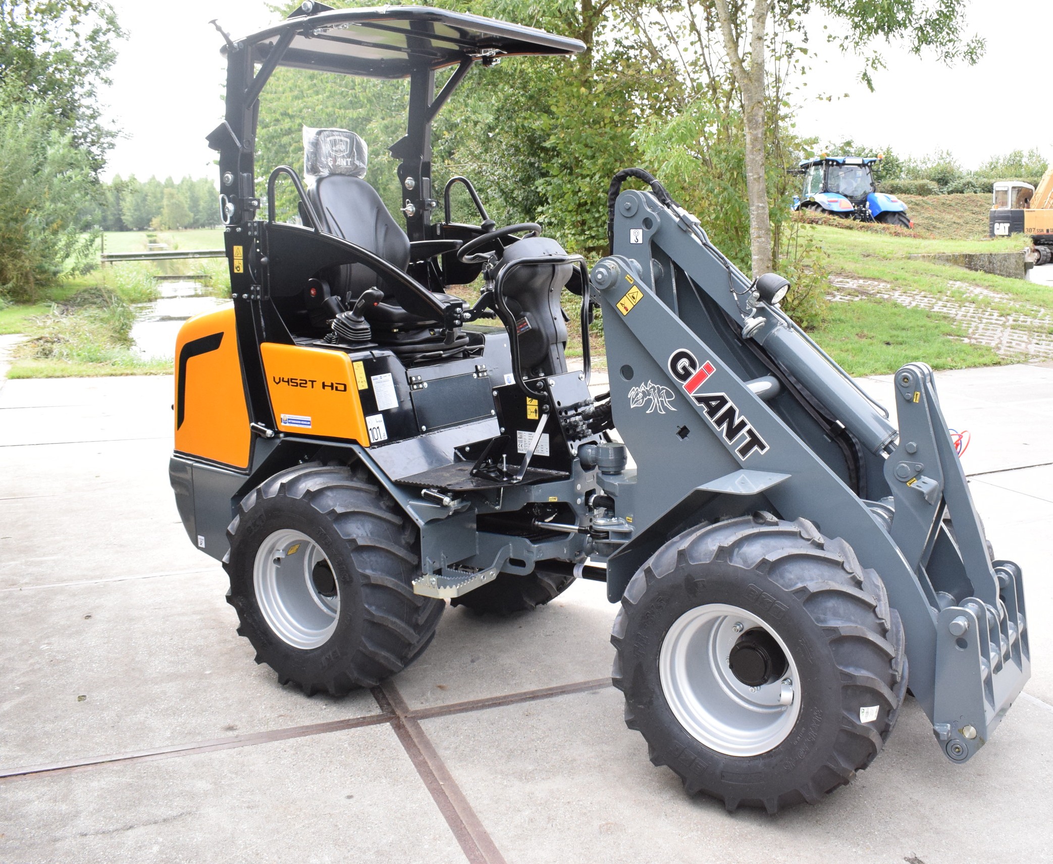 Eight shirts arranged on table in black, olive, grey, blue, white, red, mustard, and green.