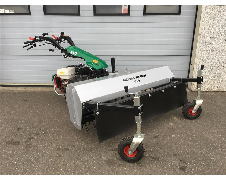 Eight shirts arranged on table in black, olive, grey, blue, white, red, mustard, and green.